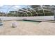 Beautiful in-ground pool is surrounded by travertine pavers and a screened enclosure at 5808 Falconcreek Pl, Lithia, FL 33547