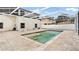 A sparkling in-ground pool is surrounded by travertine pavers and a screened enclosure at 5808 Falconcreek Pl, Lithia, FL 33547