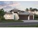 Attractive single-story home with three-car garage and landscaped front yard at 1500 Lugano Cir, Nokomis, FL 34275