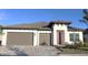 Two-story house with two-car garage, light-colored walls, and brown roof at 2016 Bolsena St, North Venice, FL 34275