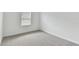 Simple bedroom with grey carpet and a window with blinds at 5213 Patano Loop, Palmetto, FL 34221