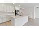 Modern kitchen with white cabinets, quartz countertops, and stainless steel appliances at 5213 Patano Loop, Palmetto, FL 34221