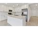 Modern kitchen with white cabinets, quartz countertops, and stainless steel appliances at 5213 Patano Loop, Palmetto, FL 34221