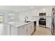 Modern kitchen with white cabinets, quartz countertops, and stainless steel appliances at 5213 Patano Loop, Palmetto, FL 34221