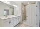 Double vanity, large mirror, and a walk-in shower in this spa-like bathroom at 5217 Patano Loop, Palmetto, FL 34221