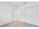 Bright bedroom with grey carpet, double door closet, and an additional door at 5217 Patano Loop, Palmetto, FL 34221