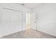 Bright bedroom with grey carpet, double door closet, and an additional door at 5217 Patano Loop, Palmetto, FL 34221