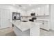This bright kitchen features white cabinets, stainless steel appliances, and a large island at 5217 Patano Loop, Palmetto, FL 34221