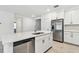 White cabinets, stainless steel appliances, and a large kitchen island highlight this modern kitchen at 5217 Patano Loop, Palmetto, FL 34221