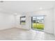 Bright living room with tile floors and sliding glass door leading to backyard at 5217 Patano Loop, Palmetto, FL 34221