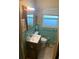 Small bathroom with teal tile and vanity at 1073 Putnam Dr, Sarasota, FL 34234