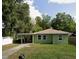 Green house with carport and spacious yard at 1073 Putnam Dr, Sarasota, FL 34234