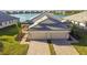 Two-story house with lake view, two-car garage, and landscaped yard at 18053 Cherished Loop, Bradenton, FL 34211