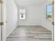 Well-lit bedroom with wood-look floors and two windows at 18053 Cherished Loop, Bradenton, FL 34211