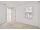 Light-filled bedroom featuring plush carpeting and an ensuite bathroom at 18053 Cherished Loop, Bradenton, FL 34211