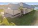 Tan house with gray roof, two-car garage, and landscaped yard at 18053 Cherished Loop, Bradenton, FL 34211