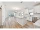 Open concept kitchen with white cabinets and island at 18053 Cherished Loop, Bradenton, FL 34211