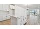 Modern kitchen with white cabinets, quartz countertops, and island at 18053 Cherished Loop, Bradenton, FL 34211