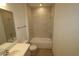 Clean bathroom with a white bathtub and marble-look tile at 310 Via Anina Dr, Sarasota, FL 34243