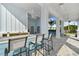 Outdoor kitchen with granite counter, barstools, and ceiling fans at 310 Via Anina Dr, Sarasota, FL 34243