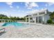 Community pool with a covered patio, lounge chairs and a separate shallow area at 310 Via Anina Dr, Sarasota, FL 34243