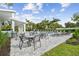 Community pool area with lounge chairs and patio tables at 310 Via Anina Dr, Sarasota, FL 34243