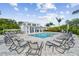 Community pool with plenty of lounge chairs for sunbathing at 310 Via Anina Dr, Sarasota, FL 34243