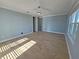 Bright bedroom with wood-look tile floors and access to hallway at 3426 79Th Street W Cir # 7-203, Bradenton, FL 34209