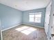 Bright bedroom with wood-look tile floors and large window at 3426 79Th Street W Cir # 7-203, Bradenton, FL 34209