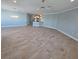 Spacious living room with light wood-look tile flooring and light blue walls at 3426 79Th Street W Cir # 7-203, Bradenton, FL 34209