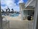 Resort-style pool with lounge chairs and a grilling station at 3426 79Th Street W Cir # 7-203, Bradenton, FL 34209