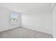 Simple bedroom with grey carpet and a window with blinds at 5406 Tripoli Dr, Palmetto, FL 34221