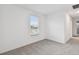 Bright bedroom with grey carpet, window, and neutral walls at 5406 Tripoli Dr, Palmetto, FL 34221