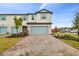 Two-story townhouse with light blue garage door and landscaping at 5406 Tripoli Dr, Palmetto, FL 34221