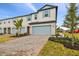 Two-story townhouse with light blue garage doors and landscaping at 5406 Tripoli Dr, Palmetto, FL 34221