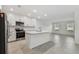 Open concept kitchen with island, stainless steel appliances, and grey tile floors at 5406 Tripoli Dr, Palmetto, FL 34221