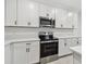 Modern kitchen features white cabinets, stainless steel appliances, and quartz countertops at 5406 Tripoli Dr, Palmetto, FL 34221