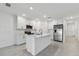 Modern white kitchen with stainless steel appliances and island at 5414 Tripoli Dr, Palmetto, FL 34221