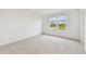 Bedroom with grey carpet and window overlooking a pond at 5418 Tripoli Dr, Palmetto, FL 34221