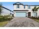 Two-story townhome with light-blue garage door and landscaped front yard at 5426 Tripoli Dr, Palmetto, FL 34221