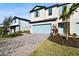 Two-story townhome with light-blue garage door and landscaped front yard at 5426 Tripoli Dr, Palmetto, FL 34221