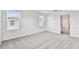 Well-lit bedroom featuring grey carpet and two windows at 5429 Tripoli Dr, Palmetto, FL 34221