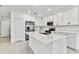 Modern kitchen with white cabinets, stainless steel appliances, and a large island at 5429 Tripoli Dr, Palmetto, FL 34221