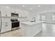 Modern kitchen with white cabinets, stainless steel appliances, and an island at 5429 Tripoli Dr, Palmetto, FL 34221