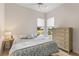 Spacious bedroom with water view and dresser at 750 Pond Lily Way, Venice, FL 34293