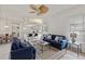 Bright living room with comfy sofas, a coffee table, and a view of the kitchen at 750 Pond Lily Way, Venice, FL 34293