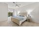 Main bedroom with sliding doors opening to the pool and patio at 750 Pond Lily Way, Venice, FL 34293