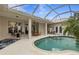 Relaxing pool area with covered patio and seating at 750 Pond Lily Way, Venice, FL 34293