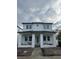 Two-story house with white exterior, dark gray roof, and landscaping at 820 46Th N Ave, St Petersburg, FL 33703