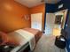 Bedroom with orange and blue walls, double closets, and view into the living area at 11854 Thicket Wood Dr, Riverview, FL 33579